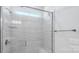 Modern bathroom shower featuring glass door, tiled walls, rainfall shower head, and a built-in niche at 231 Miramar Dr, York, SC 29745