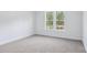 This bedroom features neutral carpet and large windows that fill the space with natural light at 231 Miramar Dr, York, SC 29745