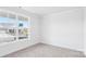 A bright bedroom with neutral carpet, a large window, and trim detail along the ceiling at 231 Miramar Dr, York, SC 29745