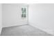 Bright bedroom features neutral carpet and a large window that fills the space with natural light at 231 Miramar Dr, York, SC 29745