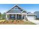 Charming two-story home featuring stone accents, gray siding, white trim, and a well-manicured front yard at 231 Miramar Dr, York, SC 29745