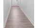 Hallway with wood floors leading to a white door at 231 Miramar Dr, York, SC 29745