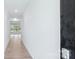 Bright hallway featuring light wood floors, white walls, a view to a living area with large windows at 231 Miramar Dr, York, SC 29745