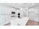 Modern kitchen with white cabinets, large island, stainless steel appliances, and open layout at 231 Miramar Dr, York, SC 29745