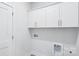 Clean laundry room featuring crisp white walls, modern cabinets, and easy access to washer and dryer hookups at 231 Miramar Dr, York, SC 29745