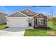 Charming single-story home with a two-car garage, stone accents and a well-manicured lawn at 249 Giant Oak Ave, Statesville, NC 28677