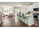 Bright, open-concept living room with hardwood floors seamlessly flows into the kitchen at 3055 Finchborough Ct # 218, Charlotte, NC 28269