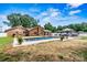 A backyard with a brick home, swimming pool, patio seating, and a lovely well kept lawn at 312 Rumple St, Troutman, NC 28166