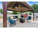 Backyard gazebo features comfortable seating around a fire pit and a lovely view of a well-manicured yard at 312 Rumple St, Troutman, NC 28166
