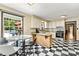Bright kitchen with black and white checkered floors, and adjacent breakfast nook overlooking the pool at 312 Rumple St, Troutman, NC 28166