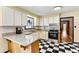 Well-lit kitchen with granite countertops, white cabinets, black and white checkered floors, and modern appliances at 312 Rumple St, Troutman, NC 28166
