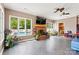 Inviting living room with brick fireplace, large windows overlooking the pool, and tiled floors at 312 Rumple St, Troutman, NC 28166