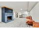 Large finished basement features a cozy blue brick fireplace and carpeted flooring throughout at 312 Rumple St, Troutman, NC 28166