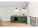 Basement bar area with green cabinets, a wine fridge, and ample counter space at 3524 Lacie Ln, Charlotte, NC 28211