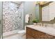 Modern bathroom featuring a glass shower with patterned tile and a wooden vanity at 3524 Lacie Ln, Charlotte, NC 28211