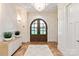 Grand foyer features herringbone floors, arched double doors, statement chandelier, and elegant trim at 3524 Lacie Ln, Charlotte, NC 28211