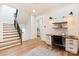 Home office with a built-in desk, floating shelves, and nearby staircase at 3524 Lacie Ln, Charlotte, NC 28211