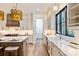 Kitchen with bright white cabinetry, open floor plan, and marble countertops at 3524 Lacie Ln, Charlotte, NC 28211