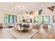 Vaulted ceiling living room with adjoining dining room and floor to ceiling windows at 3524 Lacie Ln, Charlotte, NC 28211