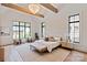 Bright primary bedroom with vaulted ceilings, wooden beams, large windows, and chandelier at 3524 Lacie Ln, Charlotte, NC 28211