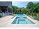 Backyard pool with attached spa and travertine tile decking at 3524 Lacie Ln, Charlotte, NC 28211