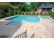 Backyard pool and spa with travertine patio and steps, and well manicured yard at 3524 Lacie Ln, Charlotte, NC 28211