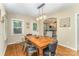 Cozy dining room with hardwood floors, a view of the kitchen, and an arched doorway at 3529 Trent St, Charlotte, NC 28209