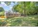 Home exterior with a well-maintained lawn, mature trees, and a charming facade at 3529 Trent St, Charlotte, NC 28209