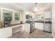 Bright kitchen featuring stainless steel appliances, white cabinetry, and a built-in desk at 3529 Trent St, Charlotte, NC 28209