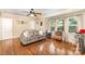 Comfortable living room with hardwood floors, neutral tones, a ceiling fan and large windows that provide natural light at 3529 Trent St, Charlotte, NC 28209