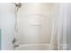 Bright shower area with tub, white tile and a shower curtain at 3529 Trent St, Charlotte, NC 28209