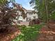 Back of the home with a spacious deck, landscaped yard, and mature trees at 3721 Providence Plantation Ln, Charlotte, NC 28270