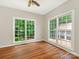 Bright, empty bedroom features two large windows and hardwood floors at 3721 Providence Plantation Ln, Charlotte, NC 28270