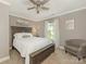 Bedroom with ceiling fan, carpeted floors, large window, and chair at 3721 Providence Plantation Ln, Charlotte, NC 28270