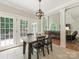 Bright dining area with French doors, a view to the backyard, and an open view to living room at 3721 Providence Plantation Ln, Charlotte, NC 28270