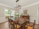 Formal dining room with a large wood table, chairs, and modern light fixture at 3721 Providence Plantation Ln, Charlotte, NC 28270