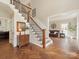 Elegant foyer showcasing a staircase with black metal spindles and herringbone wood floors at 3721 Providence Plantation Ln, Charlotte, NC 28270