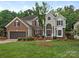 Beautiful two-story brick home with manicured lawn, mature tree, and attached two car garage at 3721 Providence Plantation Ln, Charlotte, NC 28270