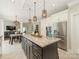 Bright eat-in kitchen features granite counters, stainless steel appliances, and pendant lighting at 3721 Providence Plantation Ln, Charlotte, NC 28270