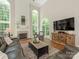 Living room with tall ceilings, large windows, and a fireplace at 3721 Providence Plantation Ln, Charlotte, NC 28270