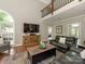 Open-concept living room with large windows, fireplace, and hardwood floors at 3721 Providence Plantation Ln, Charlotte, NC 28270