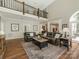 Living room with a high ceiling, view to the landing above, and an open floor plan at 3721 Providence Plantation Ln, Charlotte, NC 28270