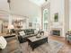 Open living room featuring high ceilings, fireplace, and view to the kitchen and dining room at 3721 Providence Plantation Ln, Charlotte, NC 28270