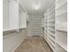 Spacious walk-in closet with carpeted floors and built-in shelving and drawers at 3721 Providence Plantation Ln, Charlotte, NC 28270