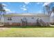 Back exterior view of the home featuring light gray siding, brick foundation, and wooden decks at 400 Joe Cloninger Rd, Bessemer City, NC 28016