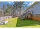 Back exterior view of the home featuring light gray siding, brick foundation, and wooden decks at 400 Joe Cloninger Rd, Bessemer City, NC 28016