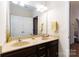 Bathroom features a double vanity with dark cabinets, framed mirror and tile flooring at 400 Joe Cloninger Rd, Bessemer City, NC 28016