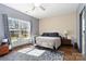 Comfortable bedroom with hardwood floors, ceiling fan, and a large window for natural light at 400 Joe Cloninger Rd, Bessemer City, NC 28016