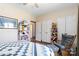 Bedroom features a ceiling fan, cozy decor, closet, and a rocking chair at 400 Joe Cloninger Rd, Bessemer City, NC 28016