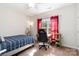 A cozy bedroom with natural light and a comfy space for relaxation and study at 400 Joe Cloninger Rd, Bessemer City, NC 28016